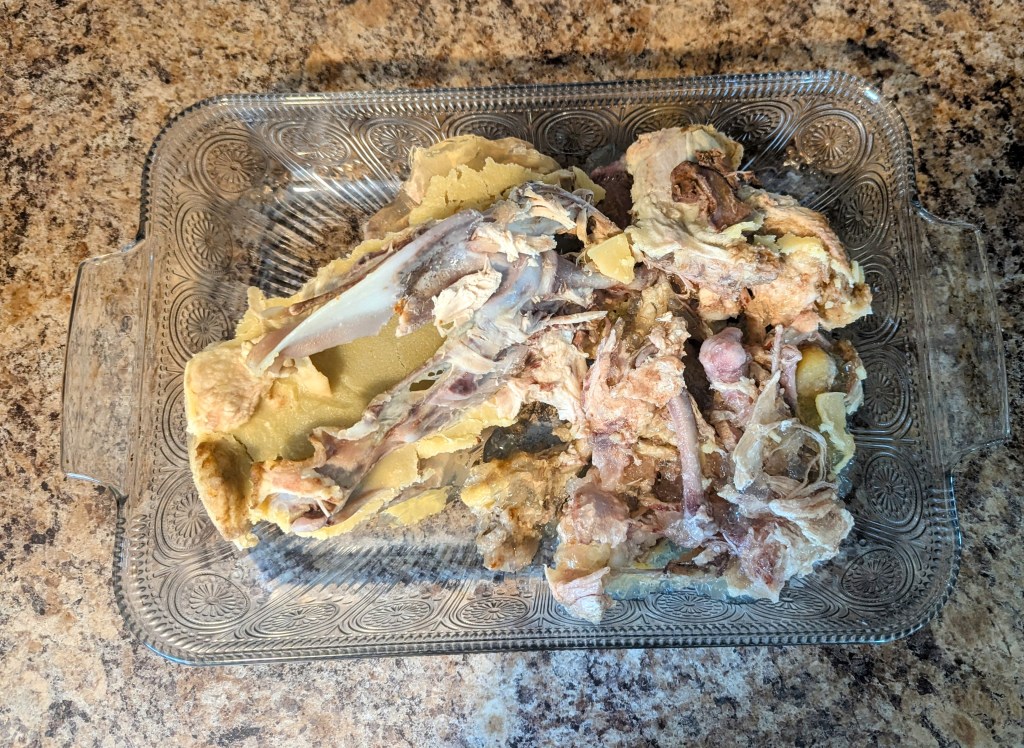 Glass pan of bones before being roasted for bone broth