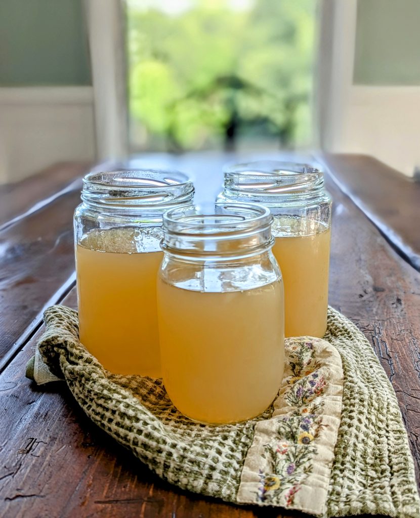 Homemade bone broth on a farmhouse table