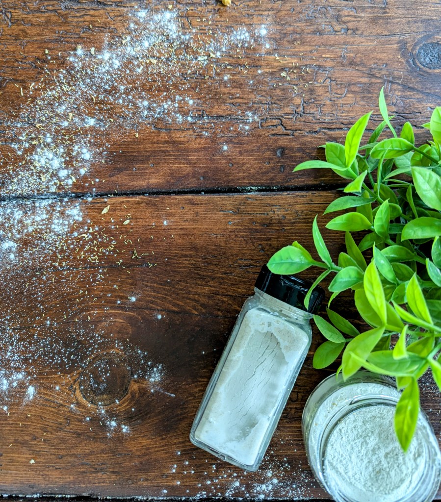 all-natural talc-free baby powder in a glass jar on a wooden farmhouse table