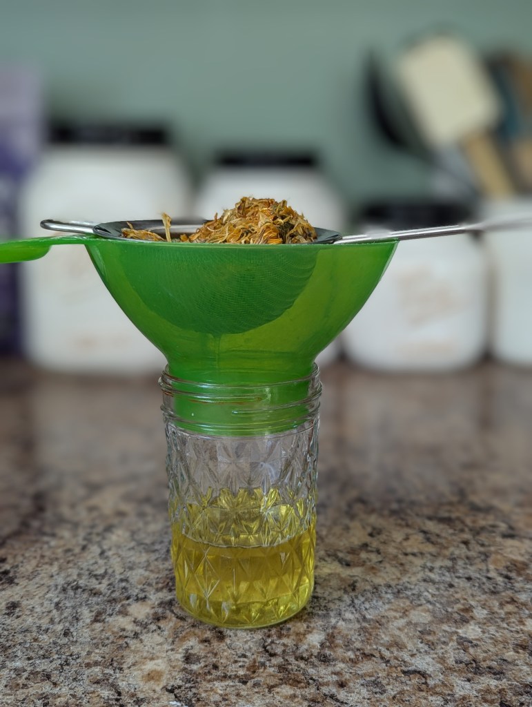 Golden calendula infusion in a glass mason jar