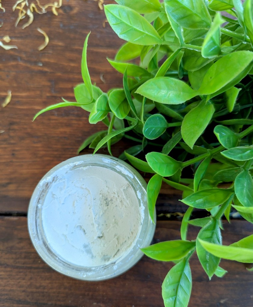 homemade natural diaper rash ointment cream on a wooden farmhouse table