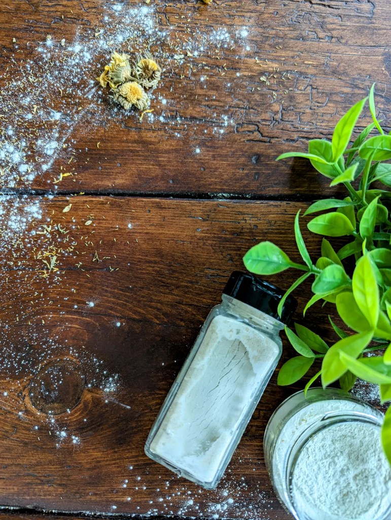 Homemade baby powder on a wooden farmhouse table