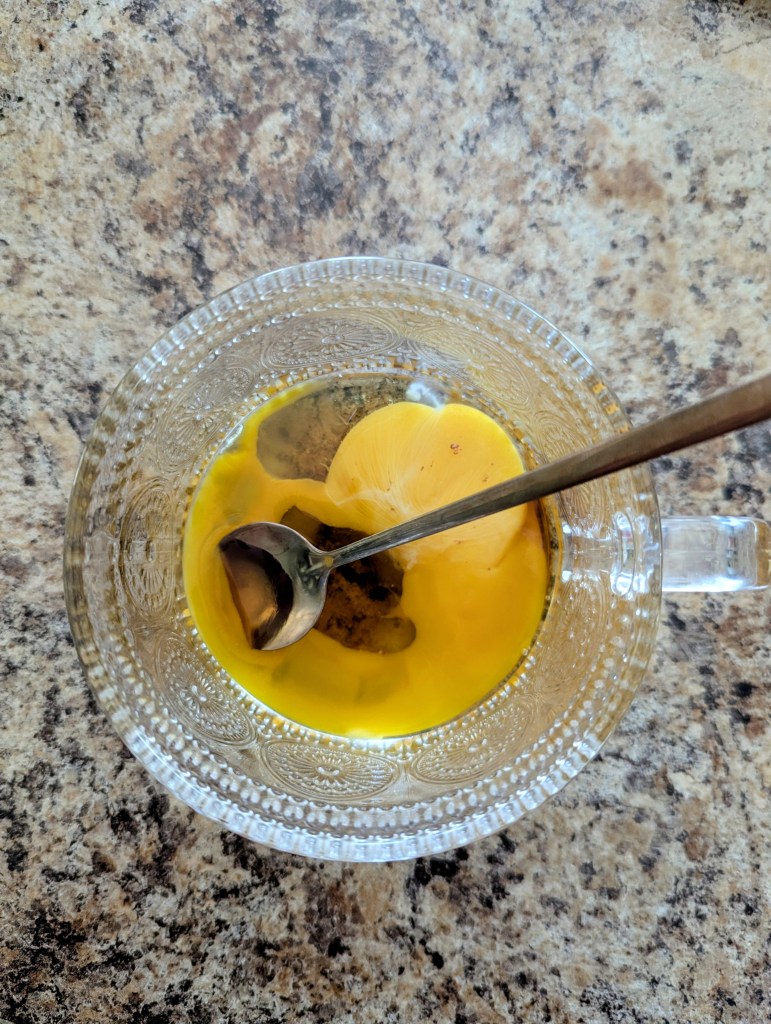 Mixing egg yolk and maple syrup for a healthy latte