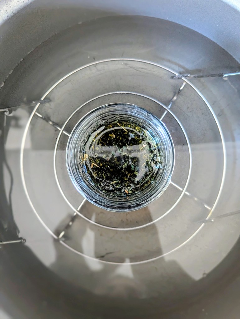 Making nettle oil for hair on the stovetop