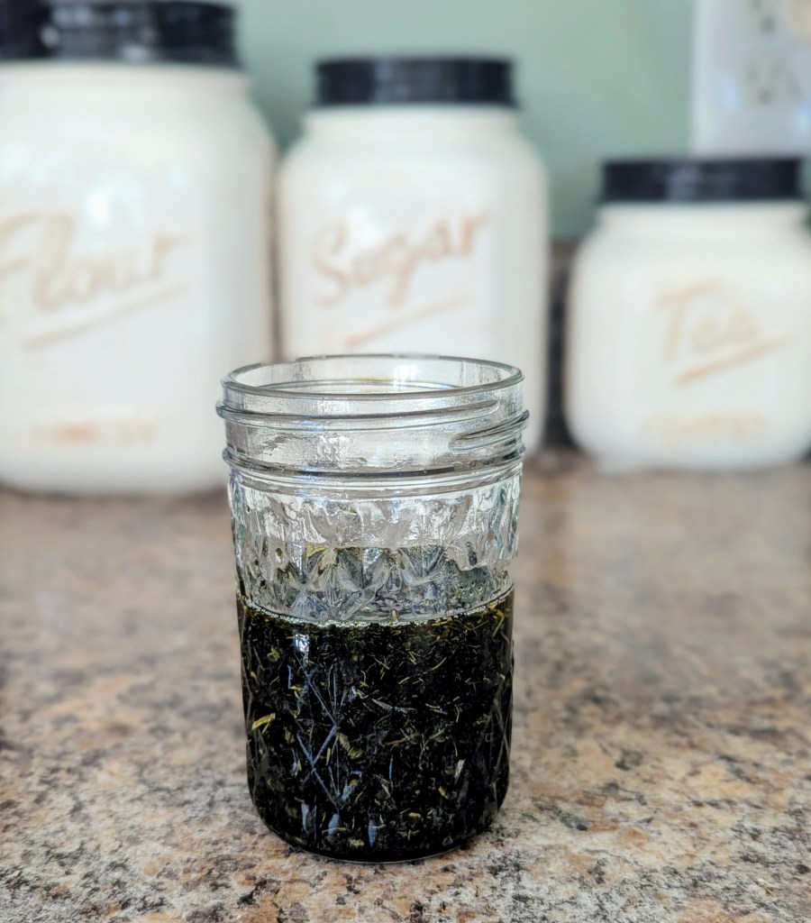 Nettle oil in a glass mason jar