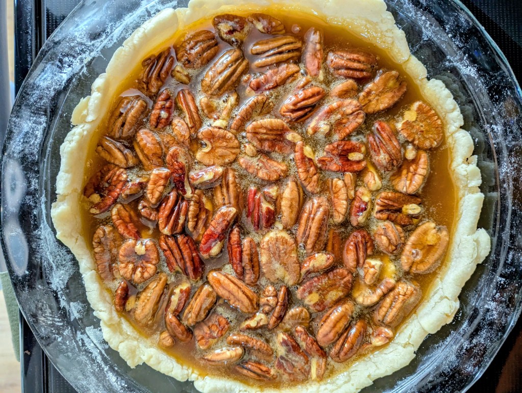unbaked pecan pie without corn syrup in a glass pie pan