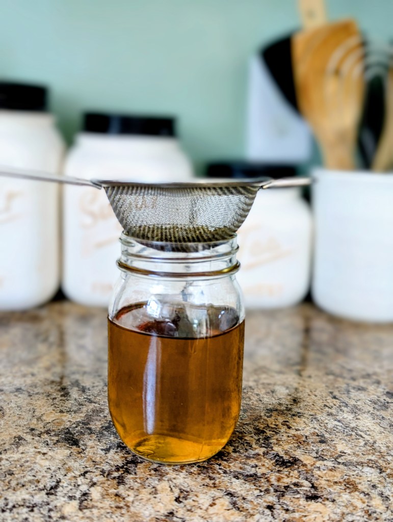 Straining dried lavender out of simple syrup
