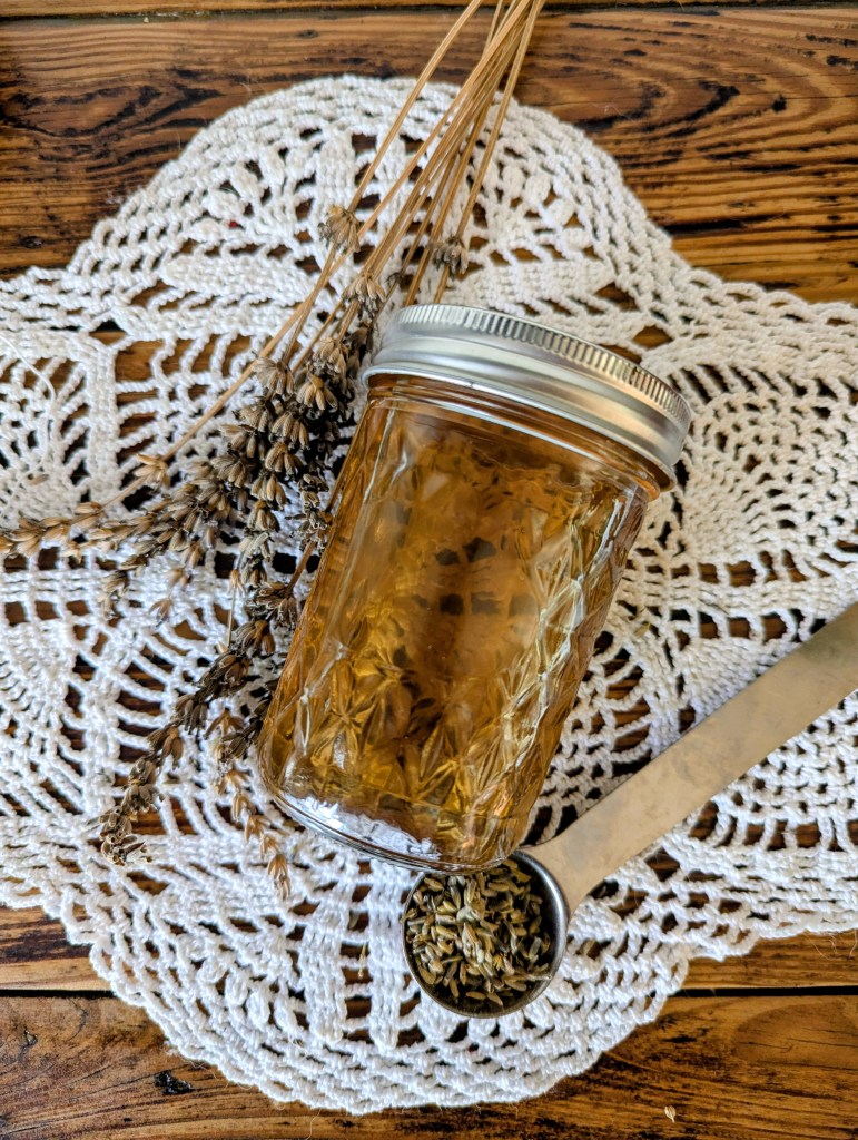 Lavender simple syrup with dried lavender on a farmhouse table