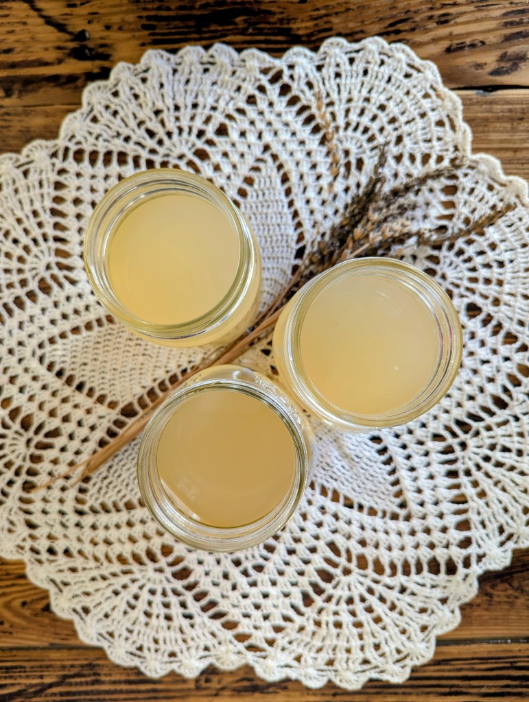 Lavender lemonade in glass mason jars on a farmhouse table