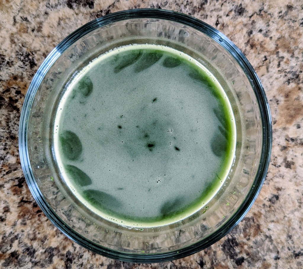 Frothy, ceremonial grade matcha in a glass dish