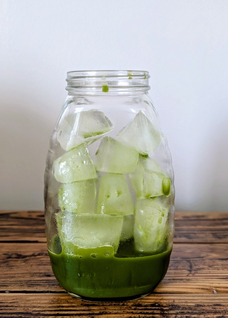 Glass of ice with matcha tea before adding milk