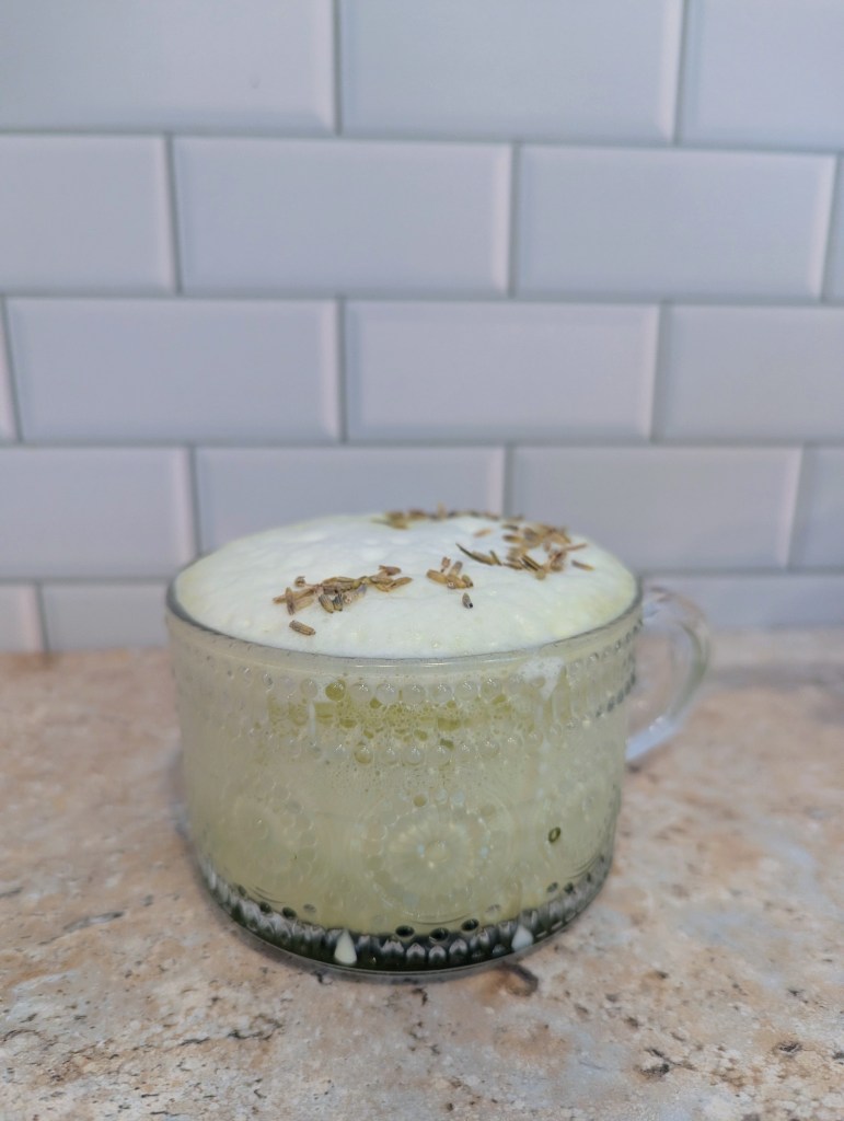 Hot lavender matcha in a glass mug