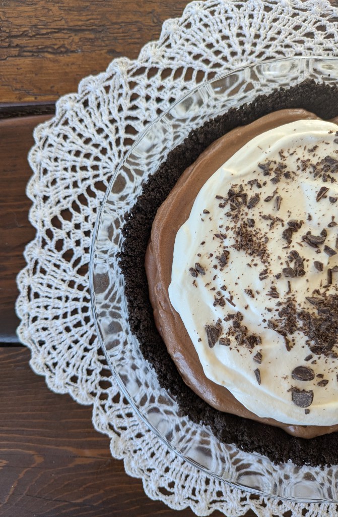 French chocolate silk pie on a wooden farmhouse table