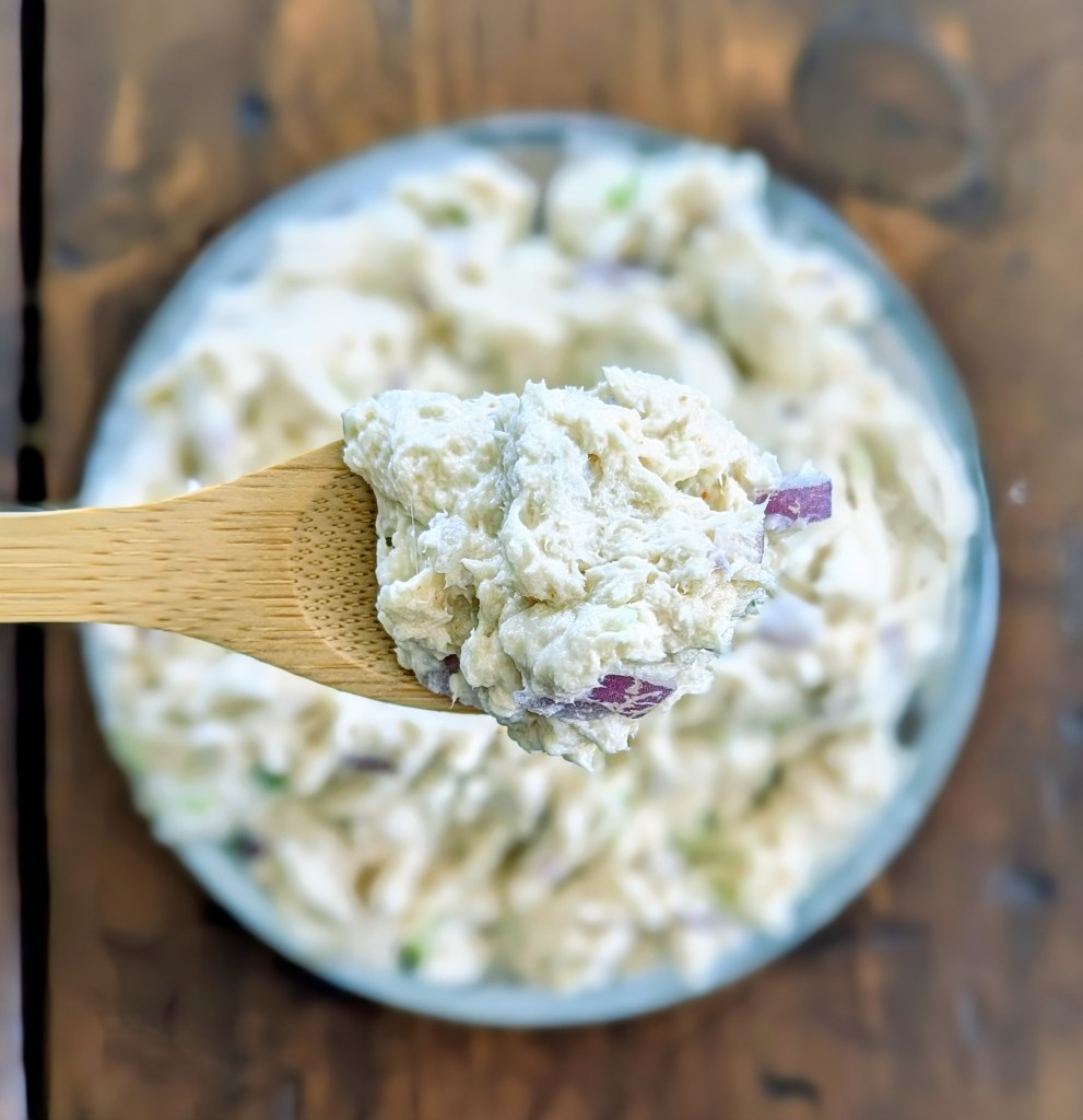 Chicken salad with Greek yogurt  scooped onto a wooden spoon