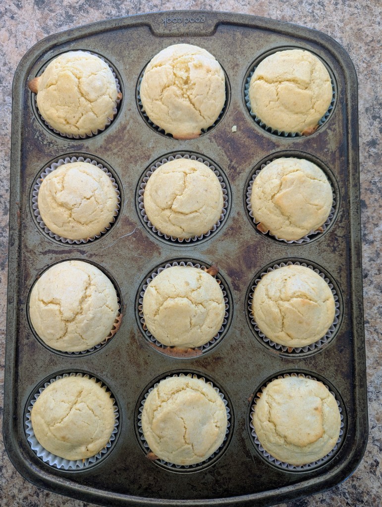 Golden brown sourdough cornbread muffins in a mufifn tin