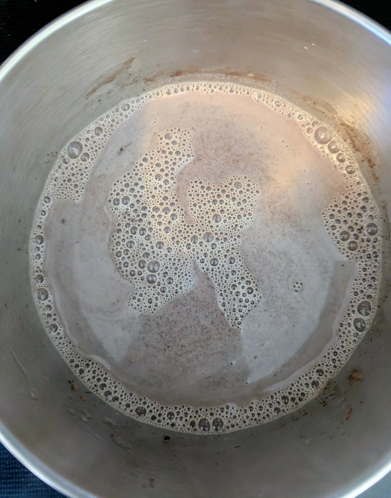 Aerial shot of bone broth hot chocolate recipe on the stovetop