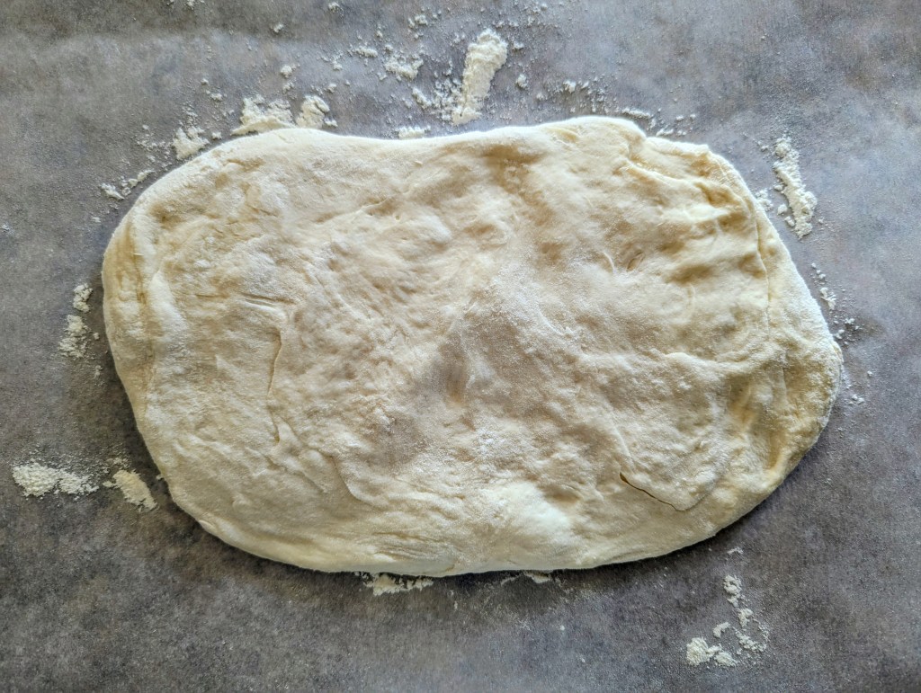 Rolling out sourdough French bread dough