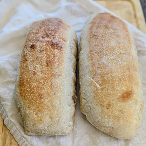 golden sourdough French bread on a farmhouse table