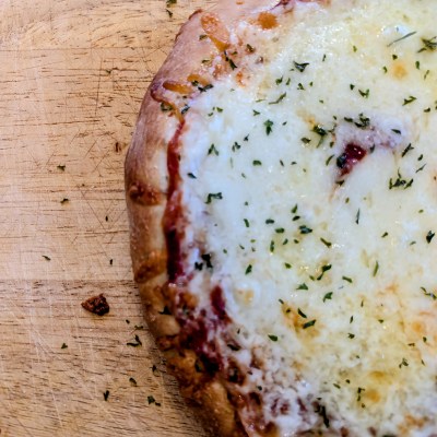 Sourdough pizza dough recipe on a wooden cutting board