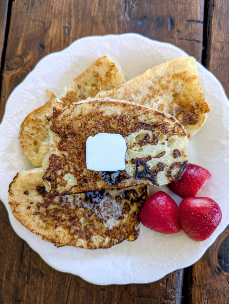Sourdough French toast with berries on a farmhouse table