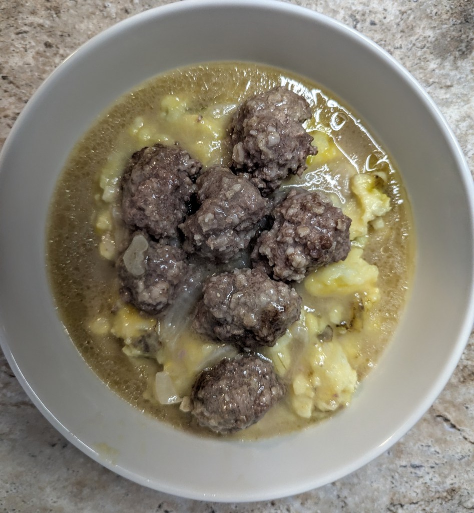 Aerial shot of meatballs and gravy with mashed potatoes