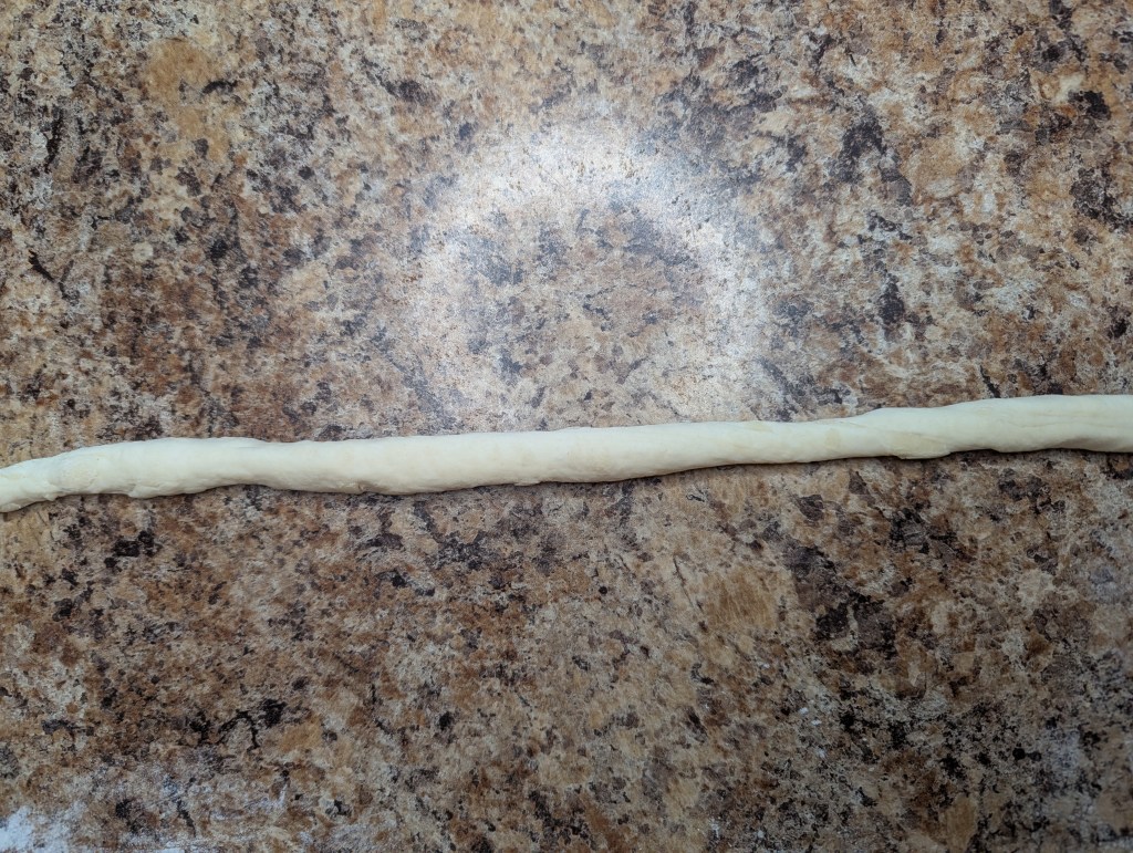 Rolling out sourdough pretzel dough