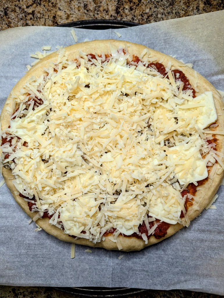 sourdough discard pizza dough with toppings before being cooked