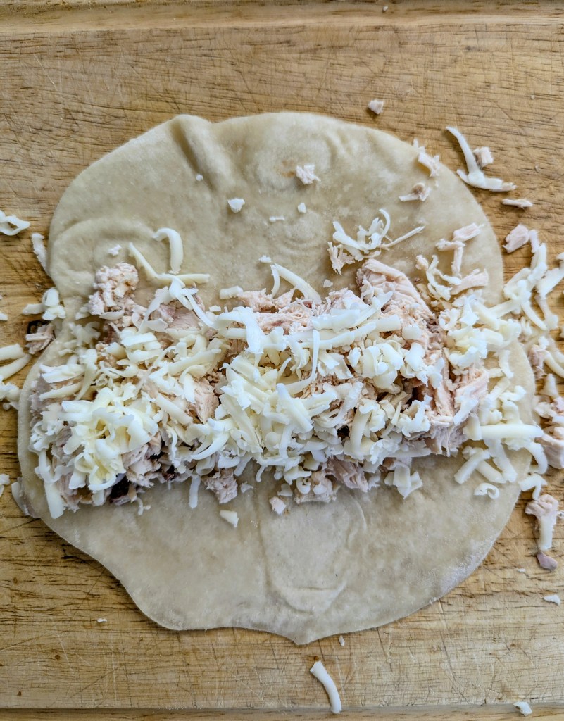 Filling tortillas wich chicken for chicken enchiladas verde