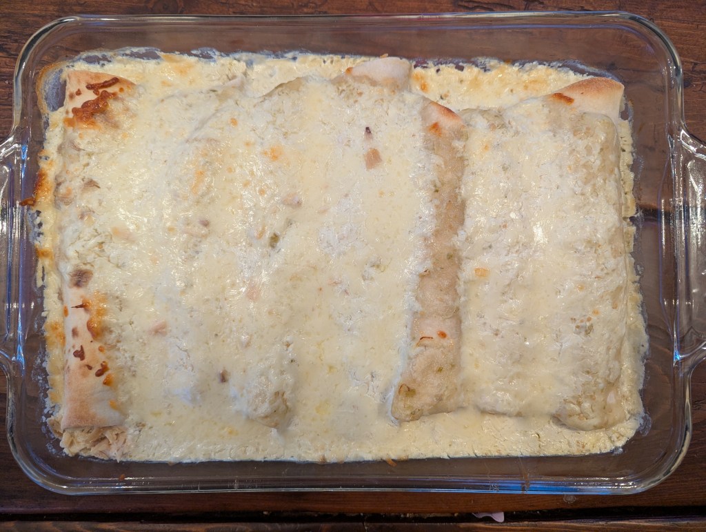 Aerial shot of chicken enchiladas verde with melted cheese