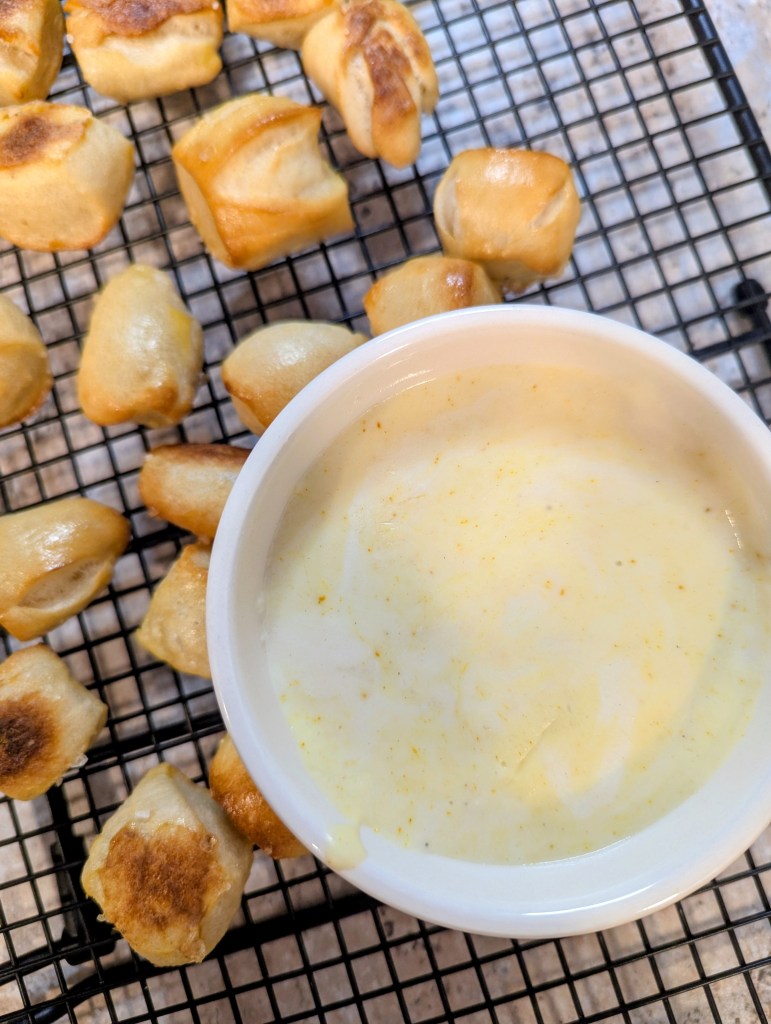Golden sourdough pretzel bites with cheese sauce