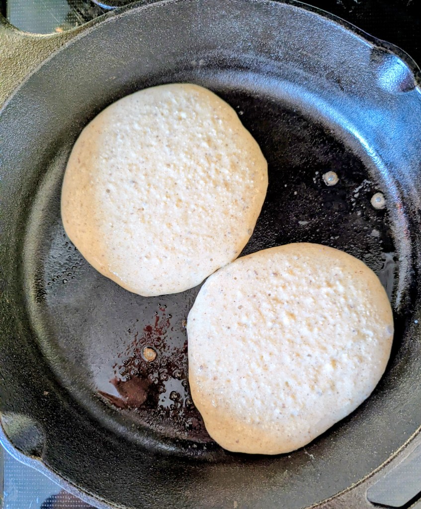 Cottage cheese protein pancakes in a cast-iron skillet