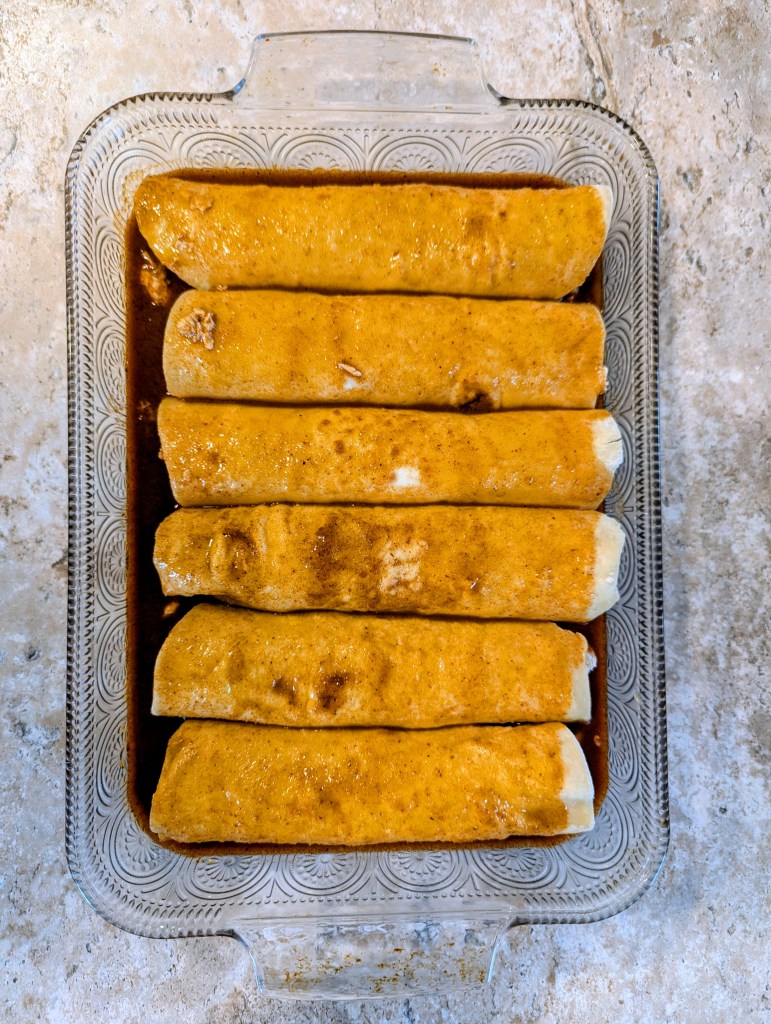 Aerial shot of chicken enchiladas with cream cheese before baking