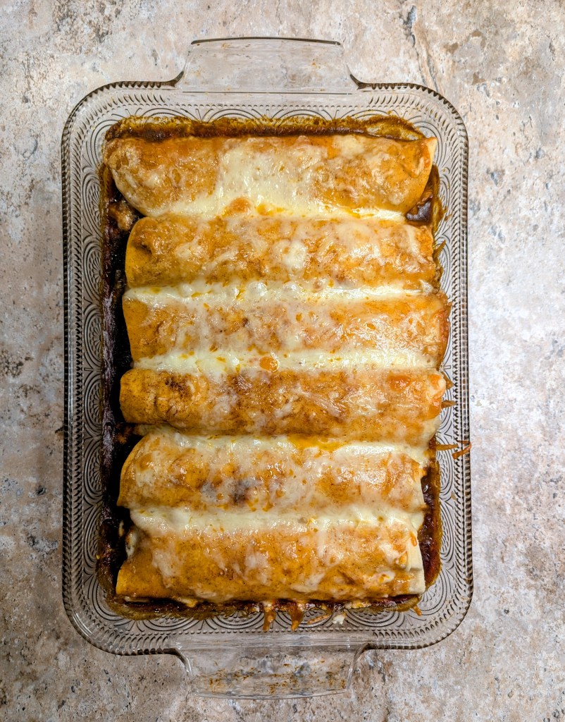 Aerial shot of golden baked chicken enchiladas with cream cheese