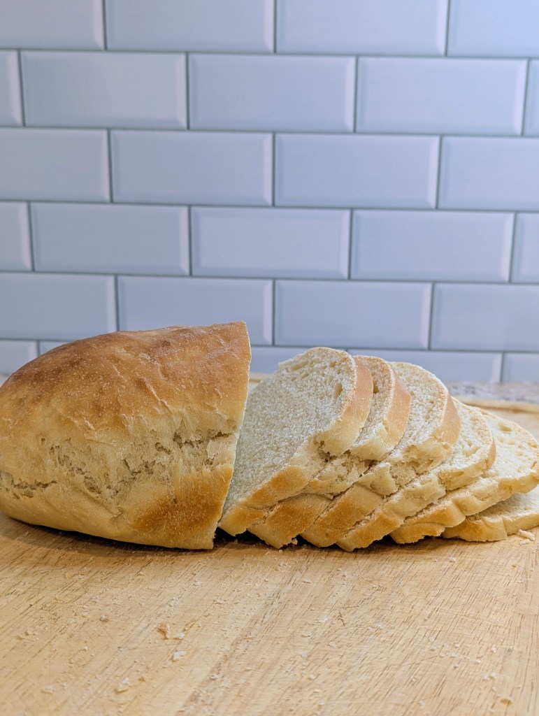 Sliced sourdough sandwich bread on a cutting board