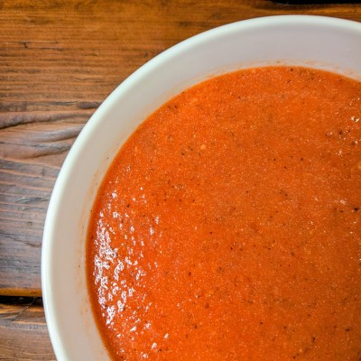 Aerial shot of tomato soup from canned tomatoes on a farmhouse table