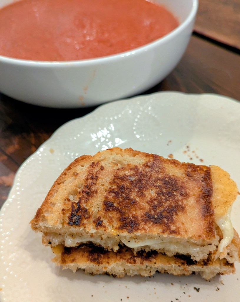 Golden sourdough grilled cheese with tomato soup