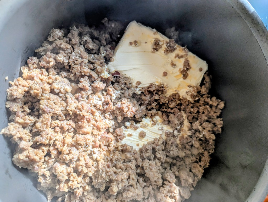 Melting cream cheese for dip with sausage, rotel, and cream cheese