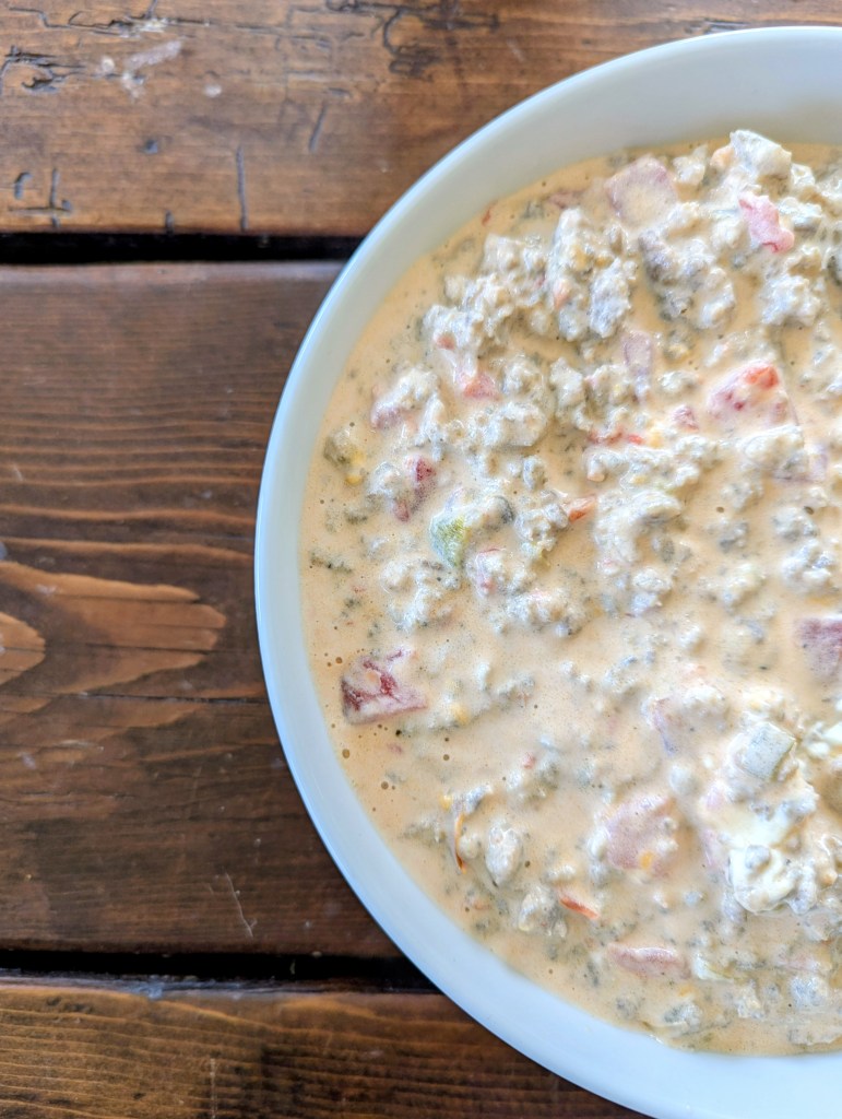 Aerial shot of sausage dip on a farmhouse table