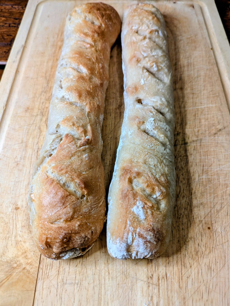 Sourdough baguette recipe on a wooden cutting board
