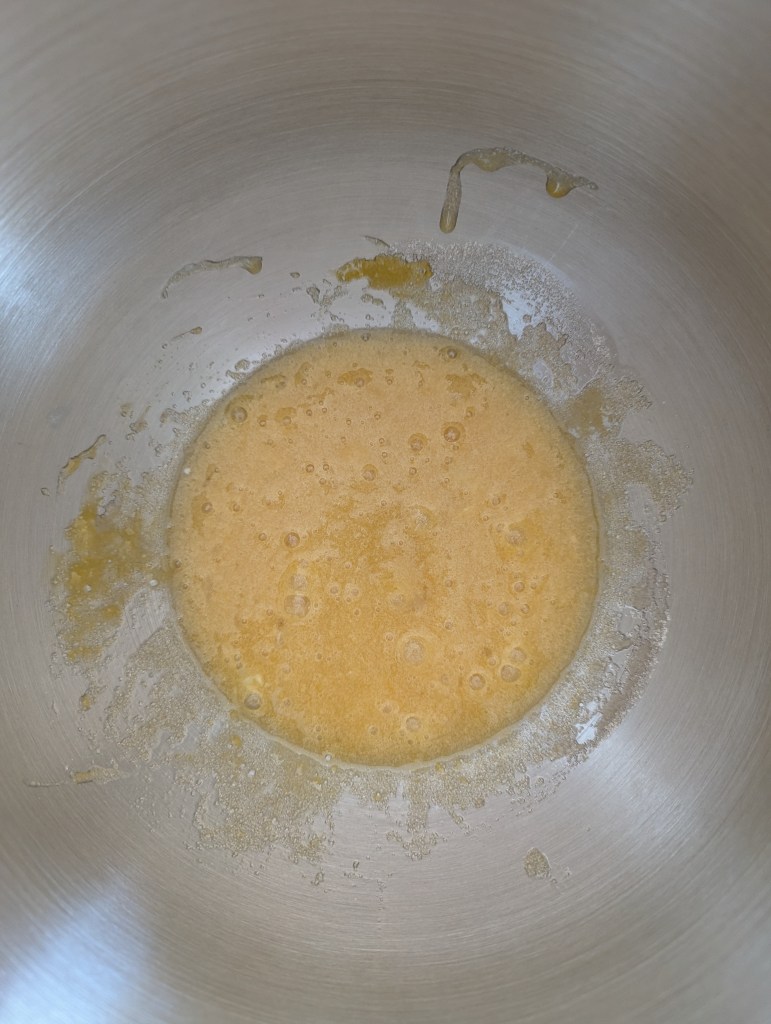 Mixing eggs and sugar for sourdough chocolate chip muffins
