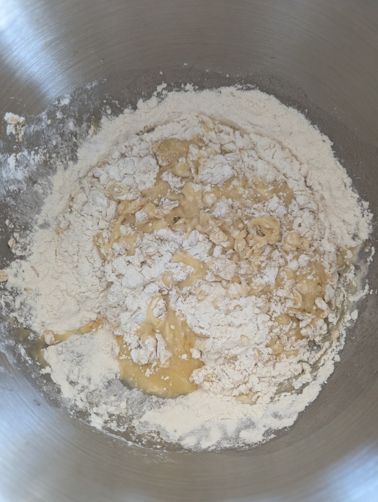 Adding dry ingredients to sourdough chocolate chip muffins