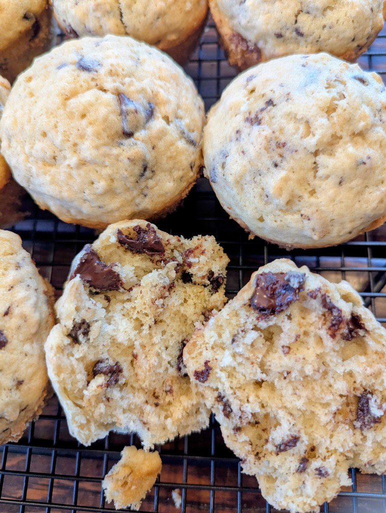 Sliced sourdough chocolate chip muffins on wire rack