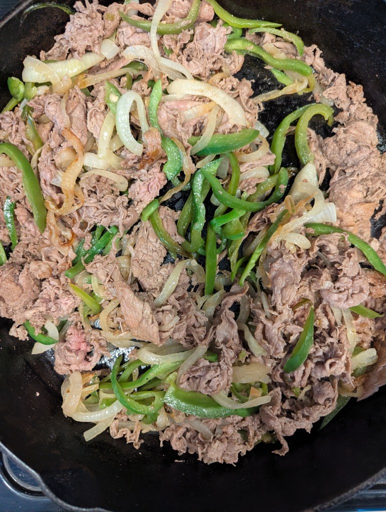 Peppers, onions and beef for Philly cheesesteaks