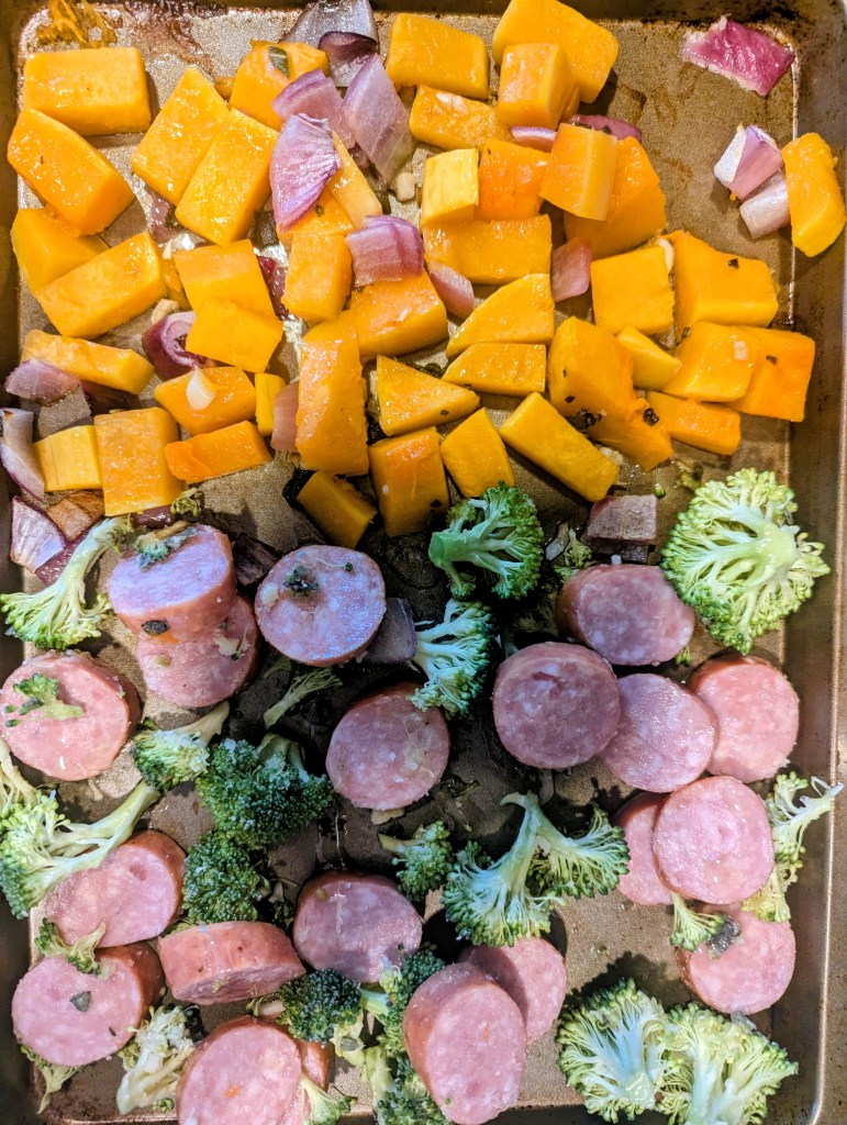 Adding broccoli and kielbasa to the kielbasa sheet pan