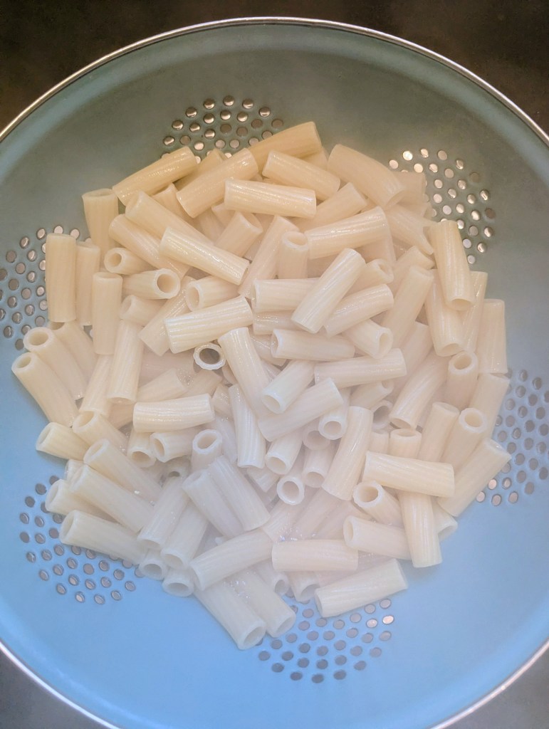 Draining pasta for kielbasa pasta