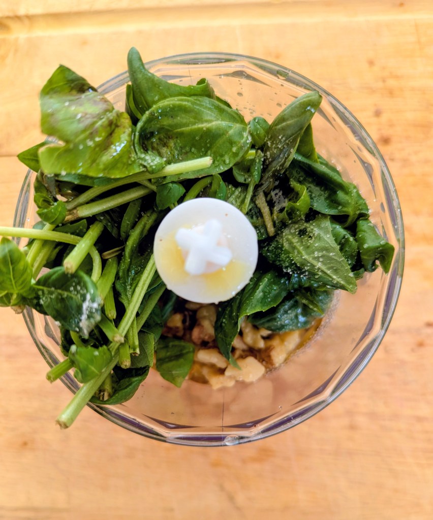 Ingredients for pesto recipe with walnuts before blending