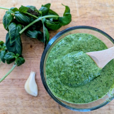 Pesto recipe with walnuts on wooden cutting board