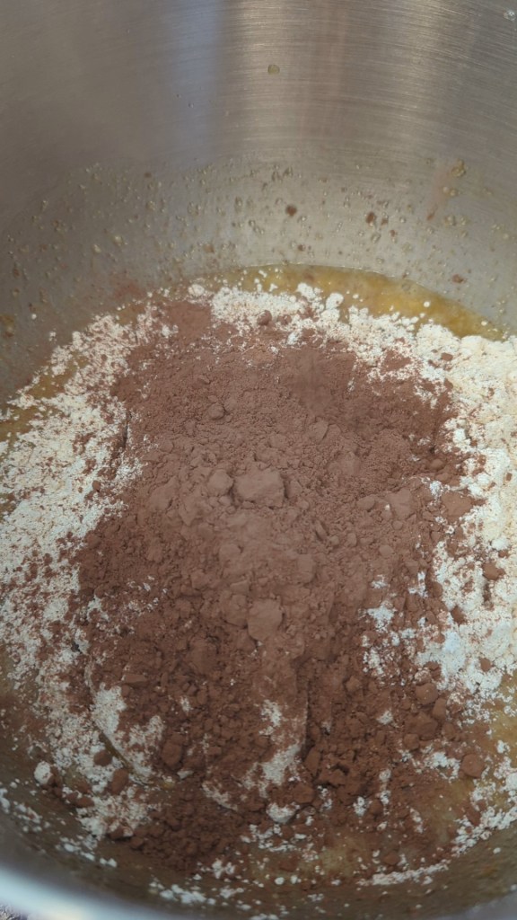Adding dry ingredients to gluten free chocolate banana bread