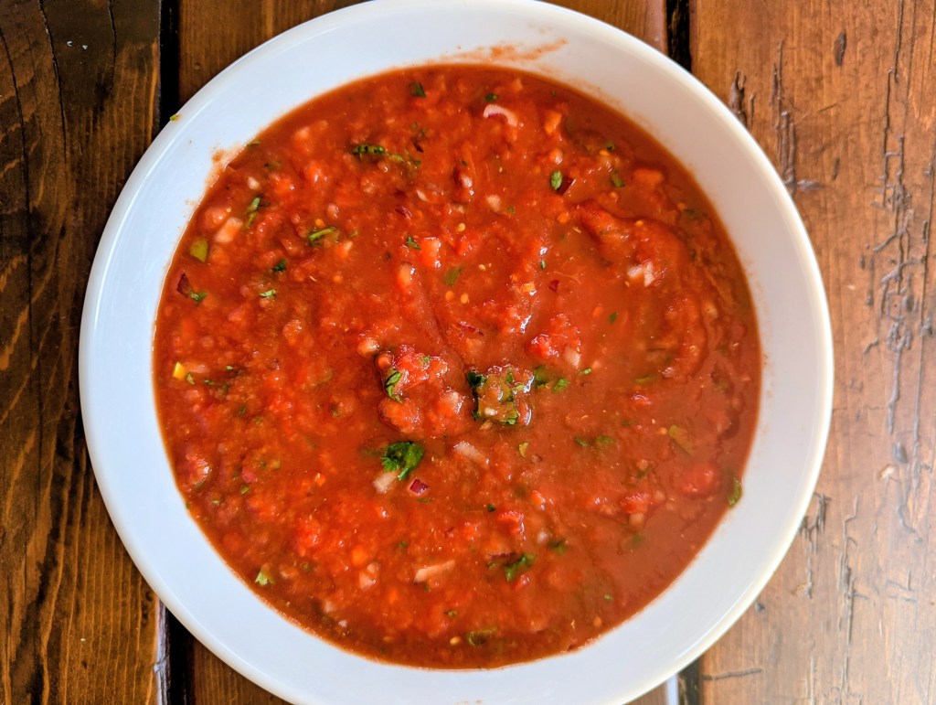 Homemade salsa with canned tomatoes on a farmhouse table