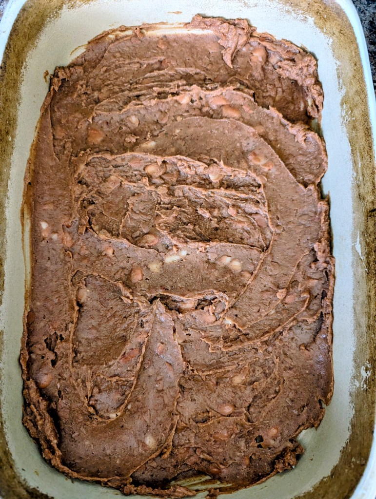 Layering refried beans for a taco casserole